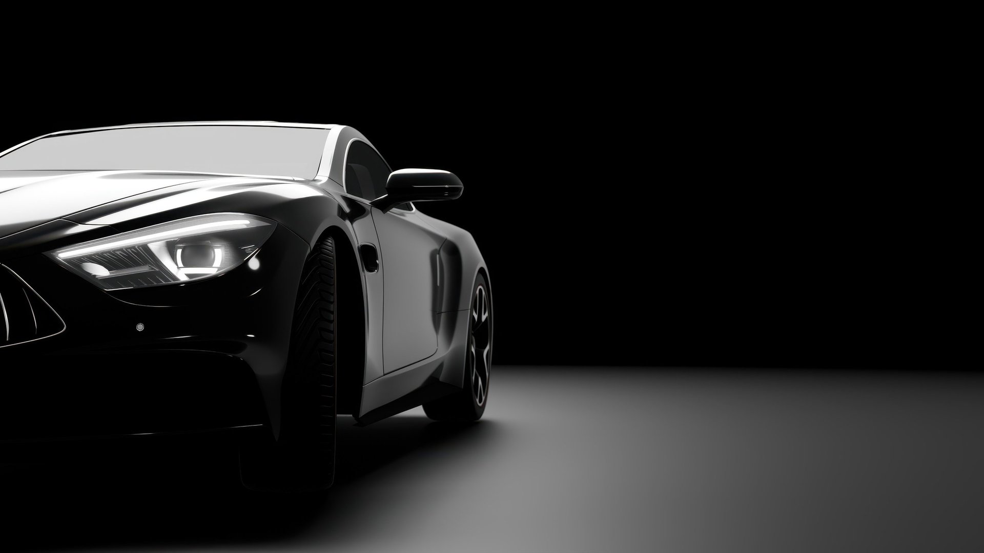 Modern black sports car emerging from the shadows with headlights on