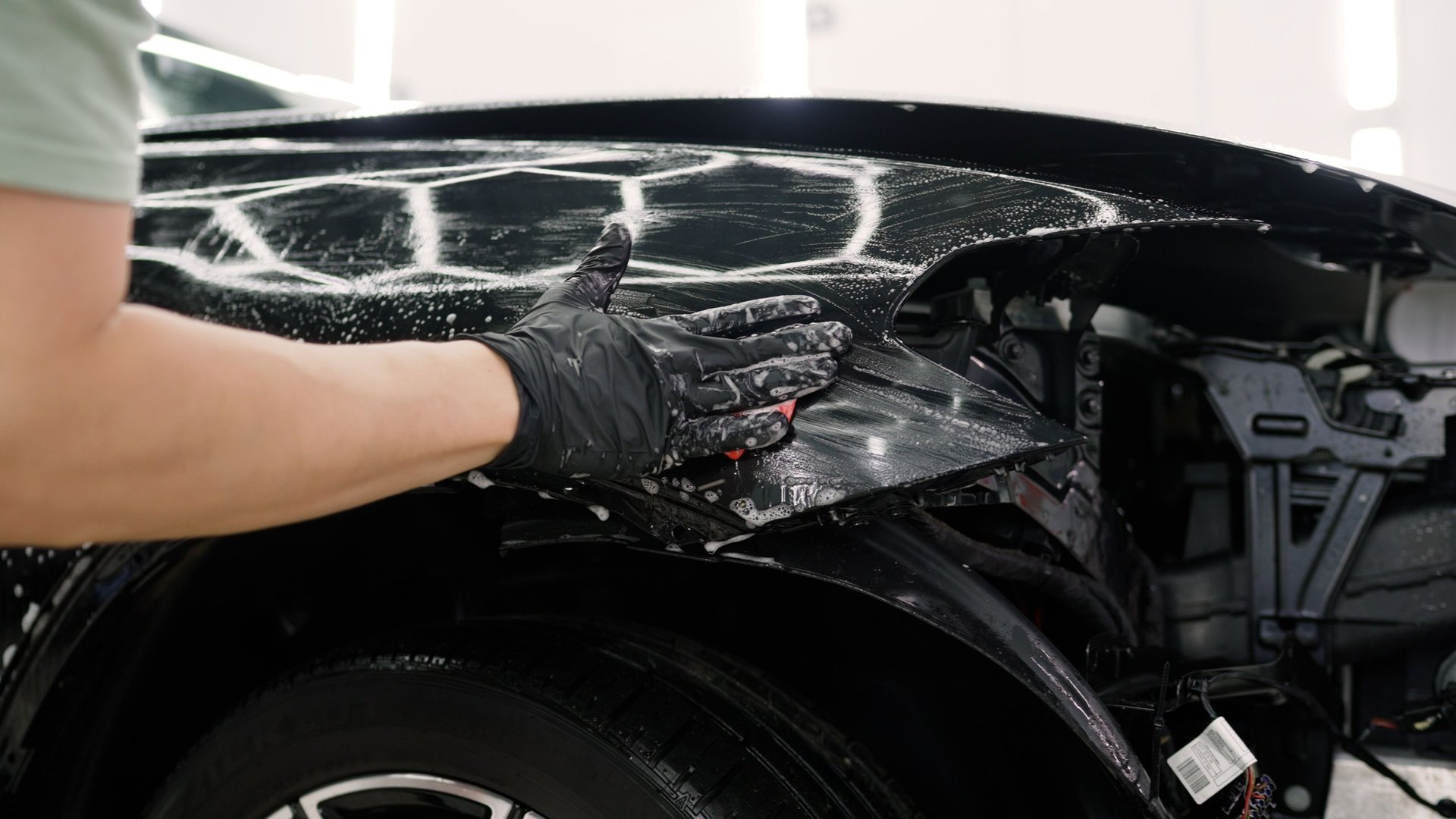 Car detailer cleaning vehicle with professional detailing products