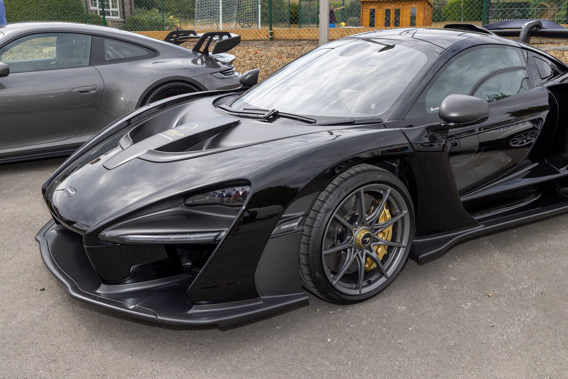 Black McLaren Senna supercar with dramatic carbon bodywork and gold brake calipers