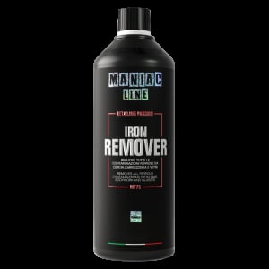 Black bottle of Maniak Iron Remover automotive cleaning product against dark background