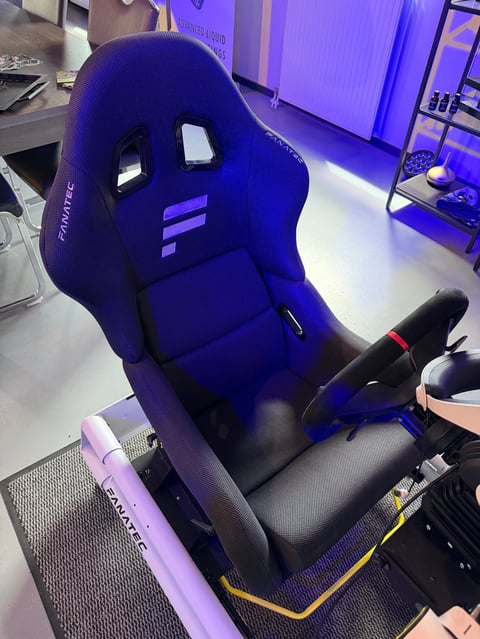 Blue and black gaming racing chair with purple illuminated background