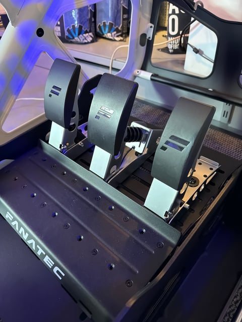 Fanatec racing simulator cockpit with dual force feedback steering wheels